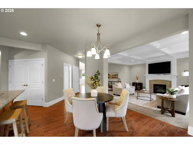a living room with furniture a fireplace and a chandelier