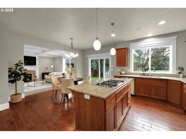 a kitchen that has a lot of cabinets a sink and a stove in it