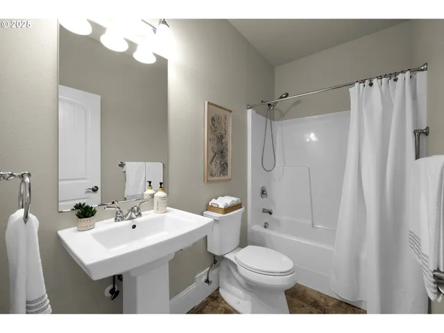 a bathroom with a sink toilet tub and shower