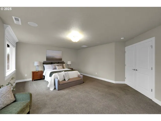 a spacious bedroom with a bed and a window