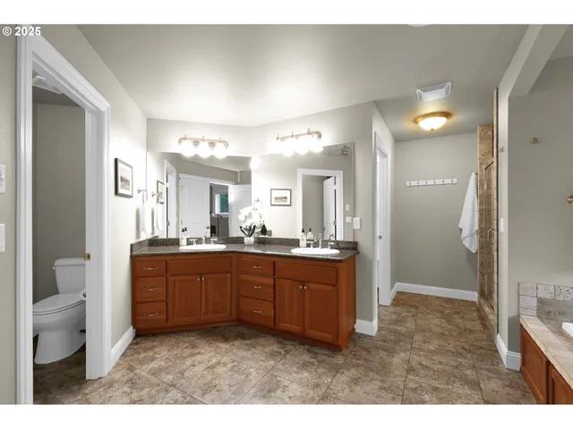 a bathroom with a sink a toilet and a mirror