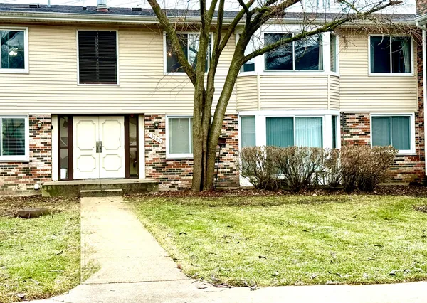 a view of a house with yard and sitting area