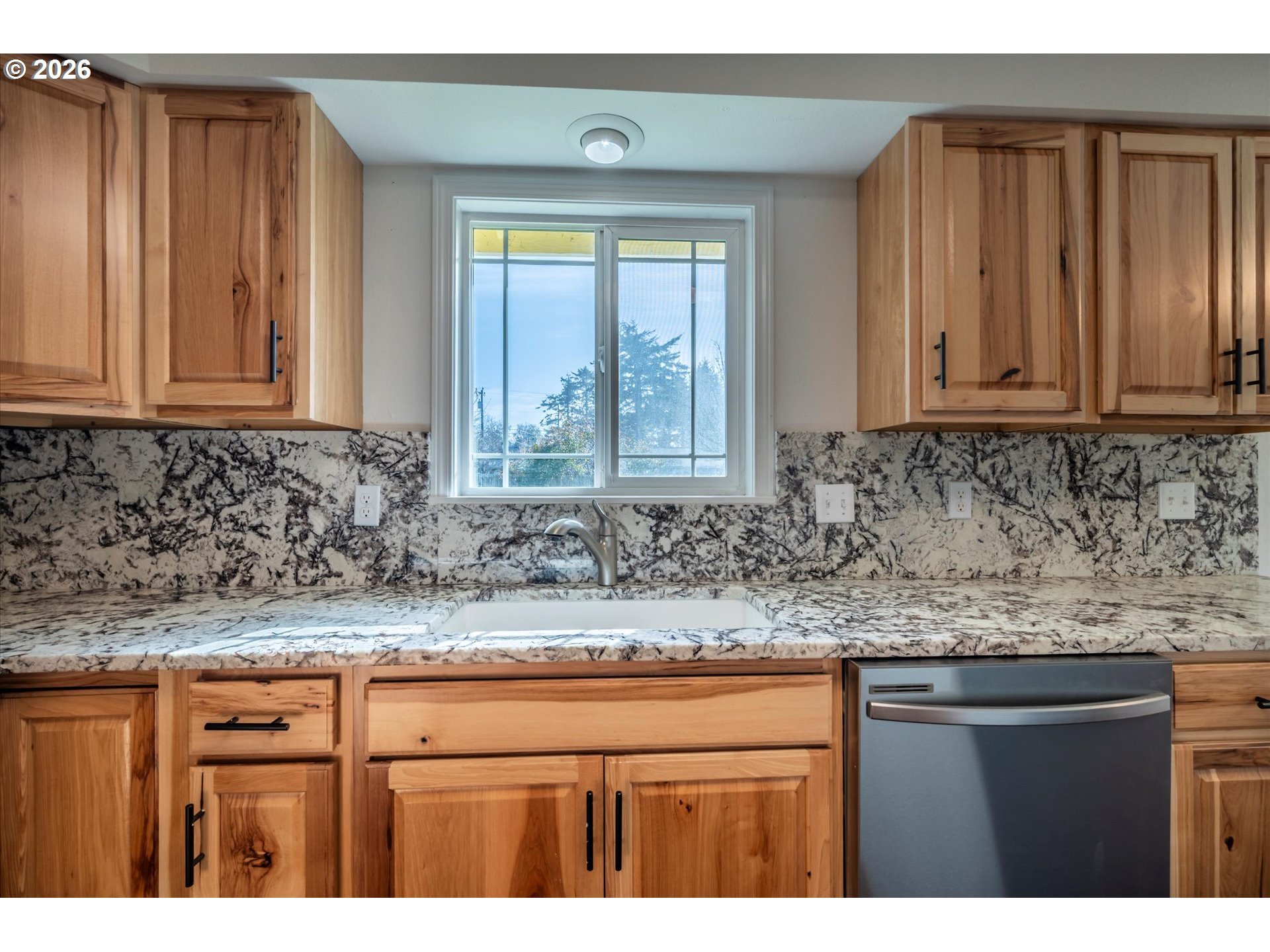 950 1st Street Northeast Bandon, OR 97411 - Photo 12 of 45 a kitchen with granite countertop cabinets and window