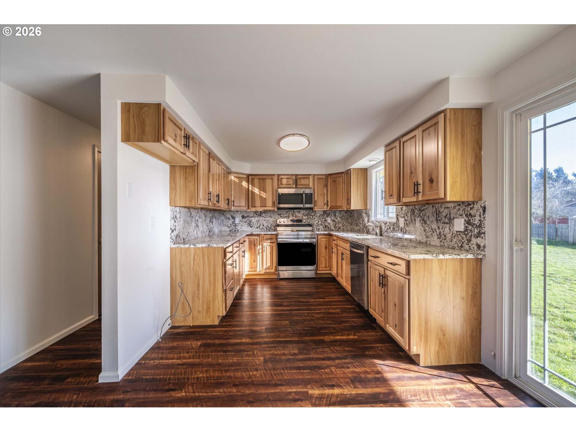 950 1st Street Northeast Bandon, OR 97411 - Photo 15 of 45 a large kitchen with cabinets and wooden floor