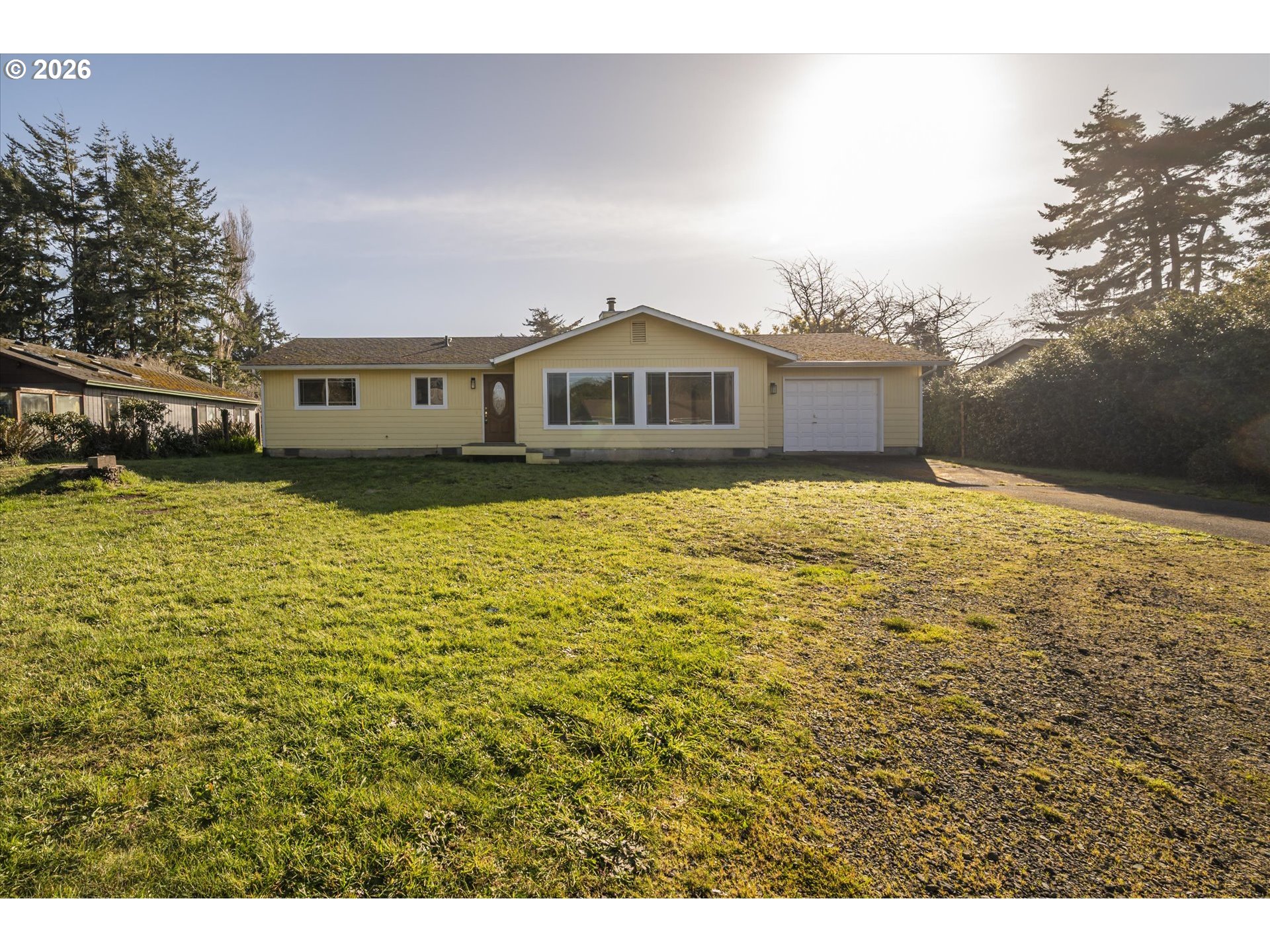 950 1st Street Northeast Bandon, OR 97411 - Photo 2 of 45 a large white house with a large pool in front of it