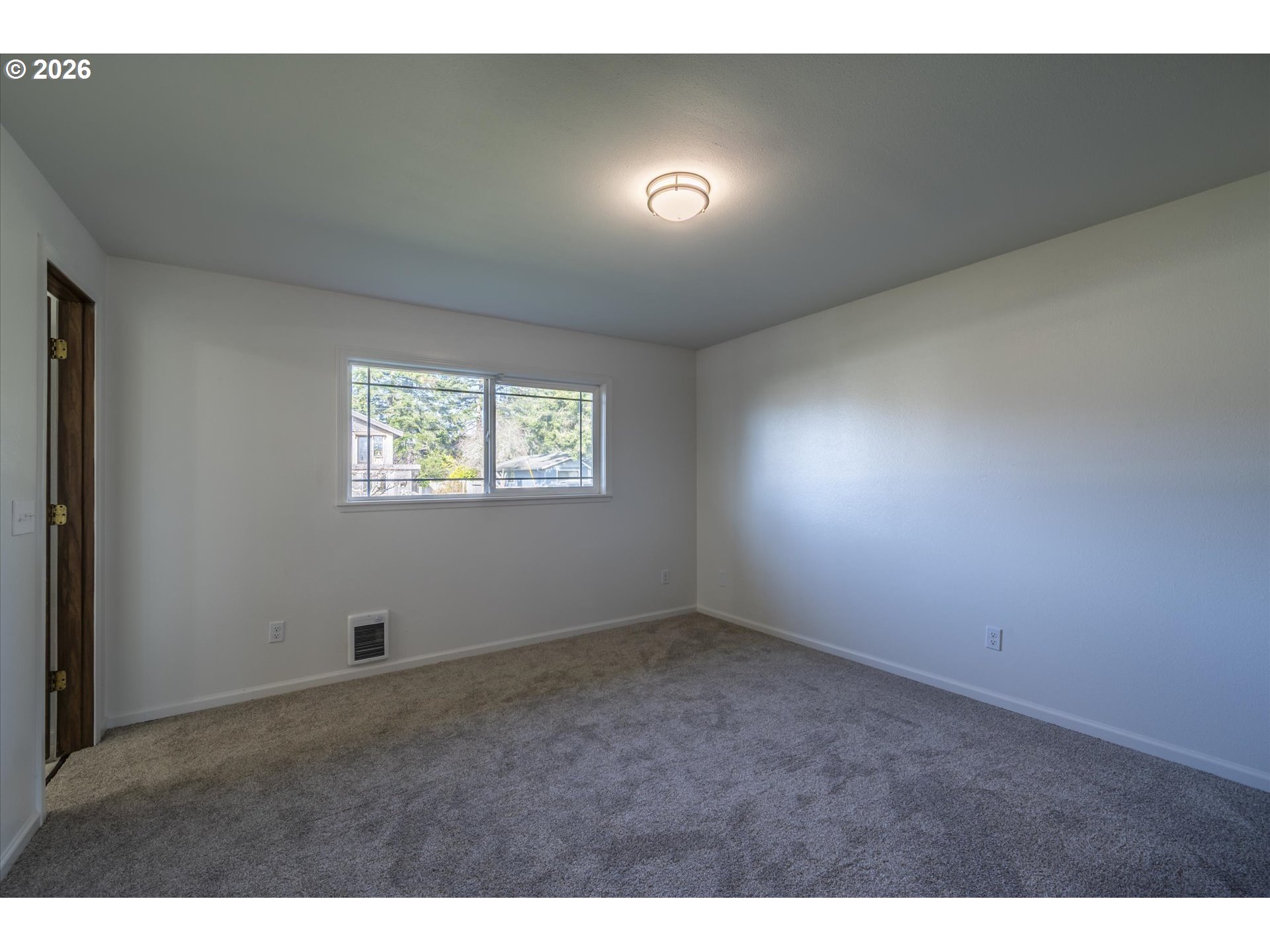 950 1st Street Northeast Bandon, OR 97411 - Photo 21 of 45 a view of an empty room and a window