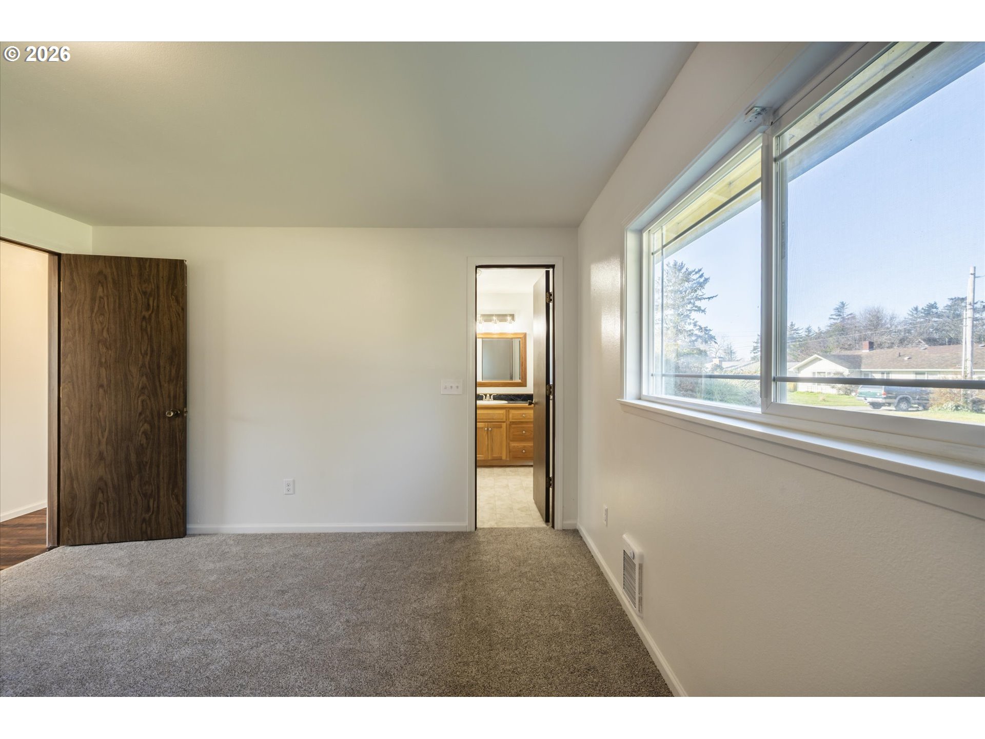 950 1st Street Northeast Bandon, OR 97411 - Photo 22 of 45 a view of an empty room and a window