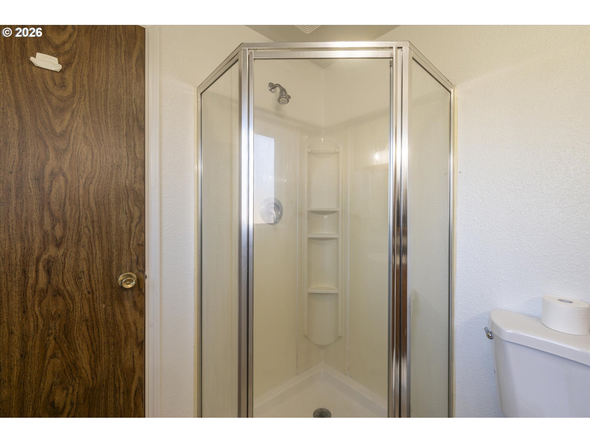 950 1st Street Northeast Bandon, OR 97411 - Photo 24 of 45 a bathroom with a glass shower door