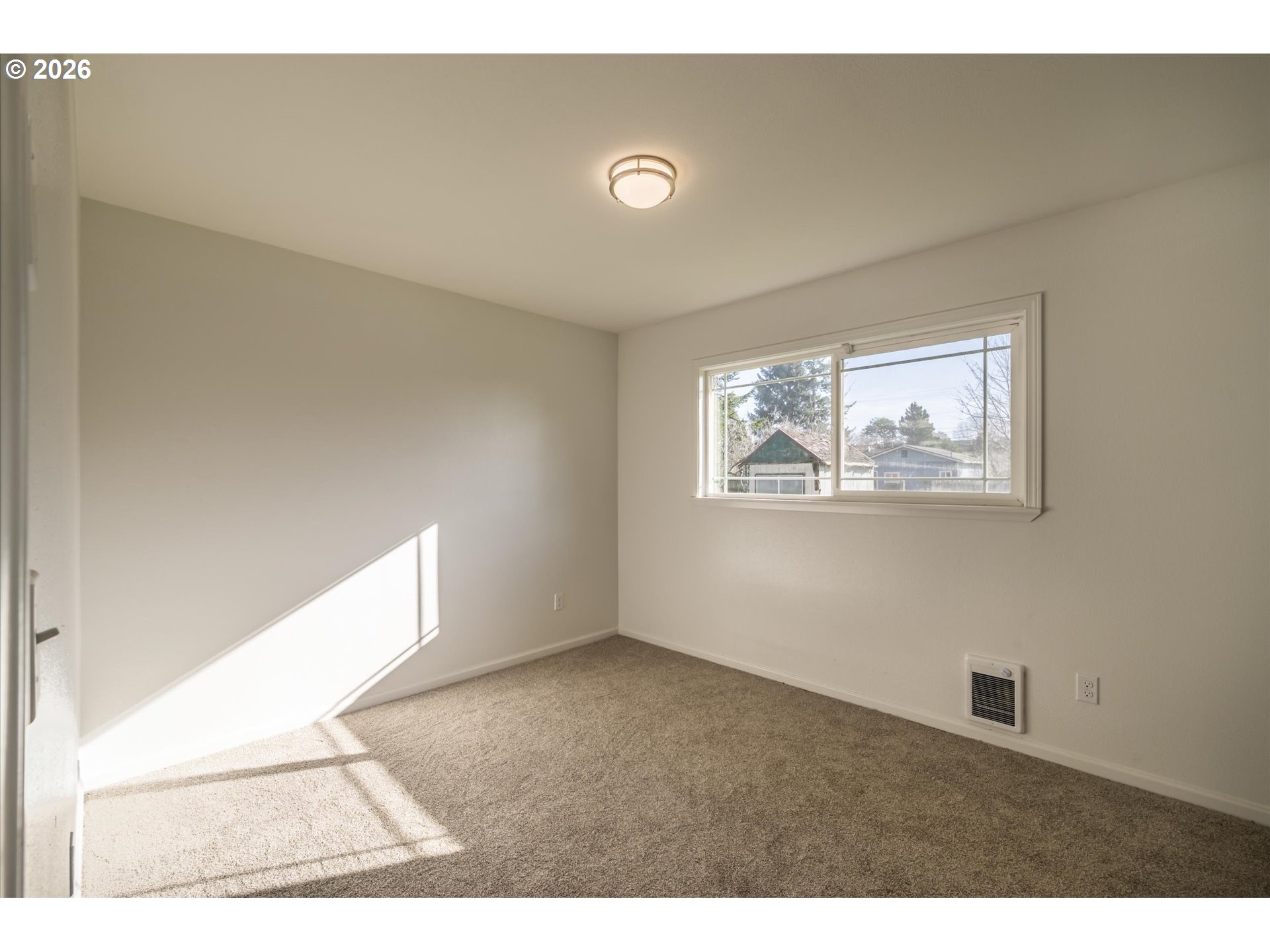 950 1st Street Northeast Bandon, OR 97411 - Photo 26 of 45 a view of an empty room with a window