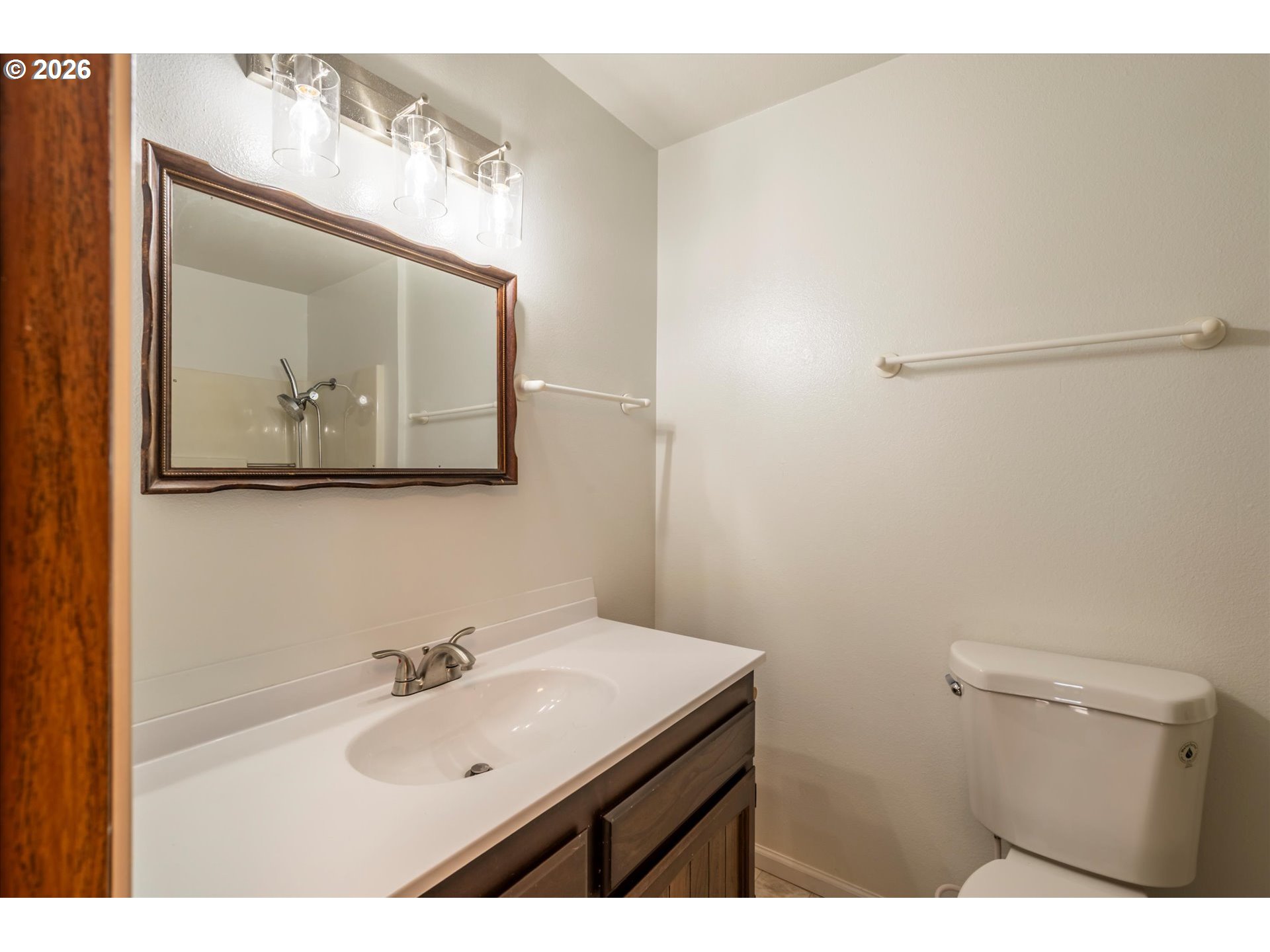 950 1st Street Northeast Bandon, OR 97411 - Photo 29 of 45 a bathroom with a sink vanity and a mirror