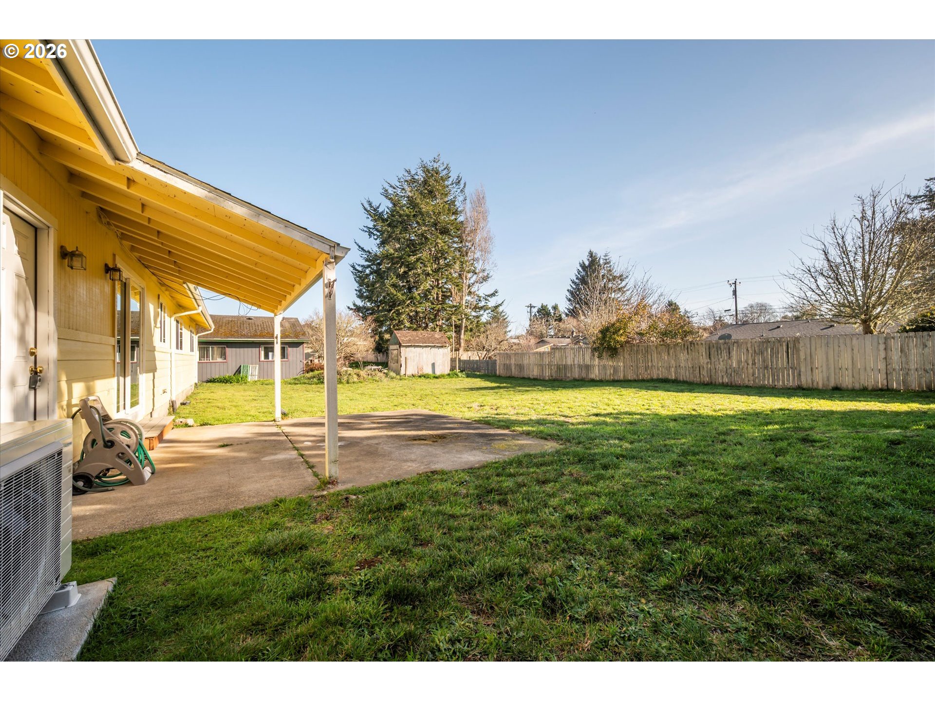 950 1st Street Northeast Bandon, OR 97411 - Photo 32 of 45 a view of swimming pool with lawn chairs and large trees
