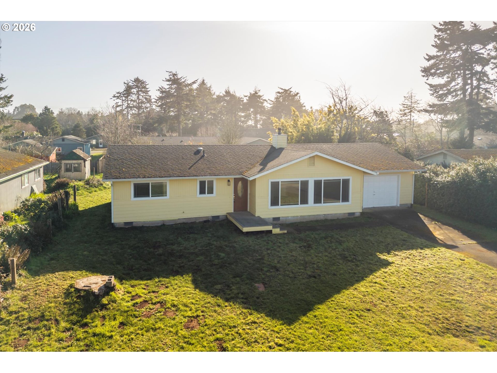 950 1st Street Northeast Bandon, OR 97411 - Photo 36 of 45 a house with trees in the background