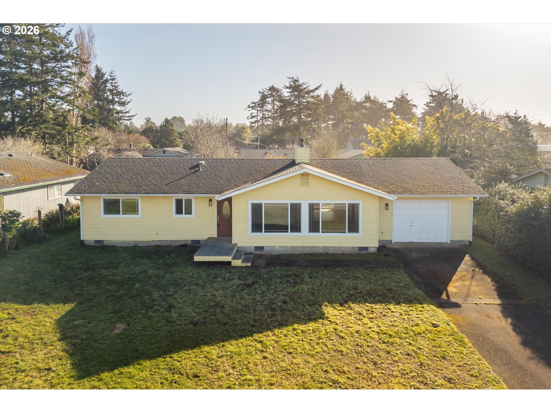 950 1st Street Northeast Bandon, OR 97411 - Photo 37 of 45 a front view of a house with a yard