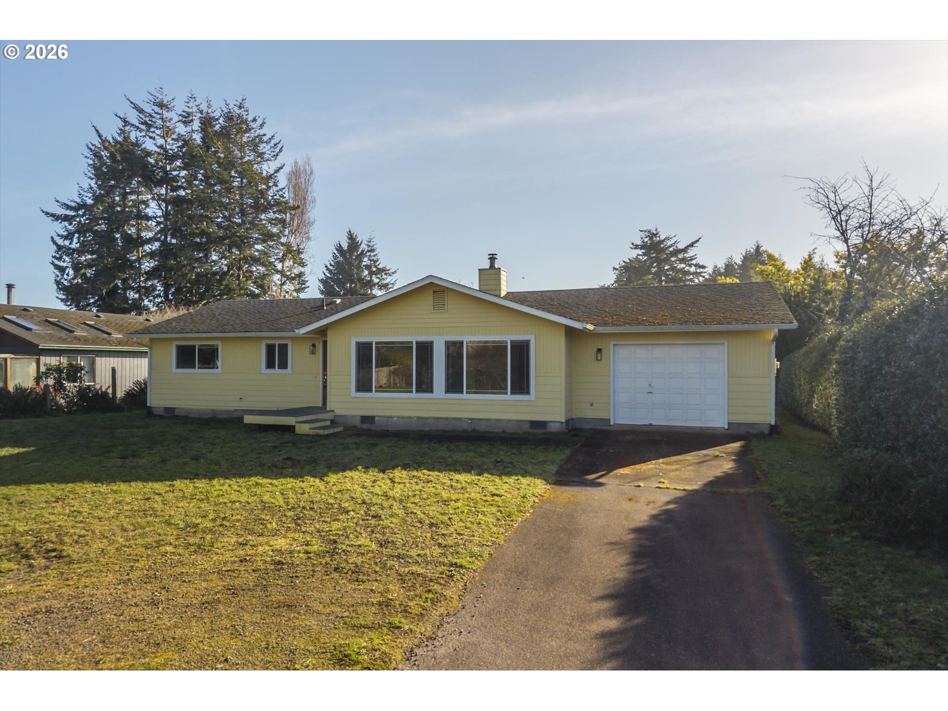 950 1st Street Northeast Bandon, OR 97411 - Photo 45 of 45 a front view of a house with a yard