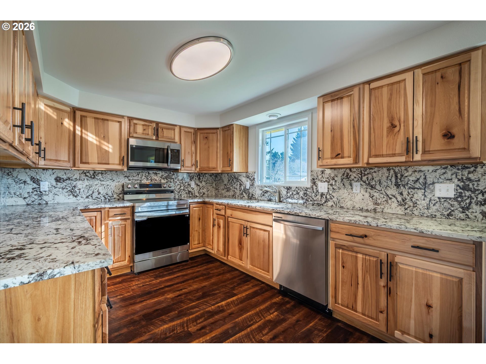 950 1st Street Northeast Bandon, OR 97411 - Photo 10 of 45 a kitchen with stainless steel appliances granite countertop a stove sink and cabinets