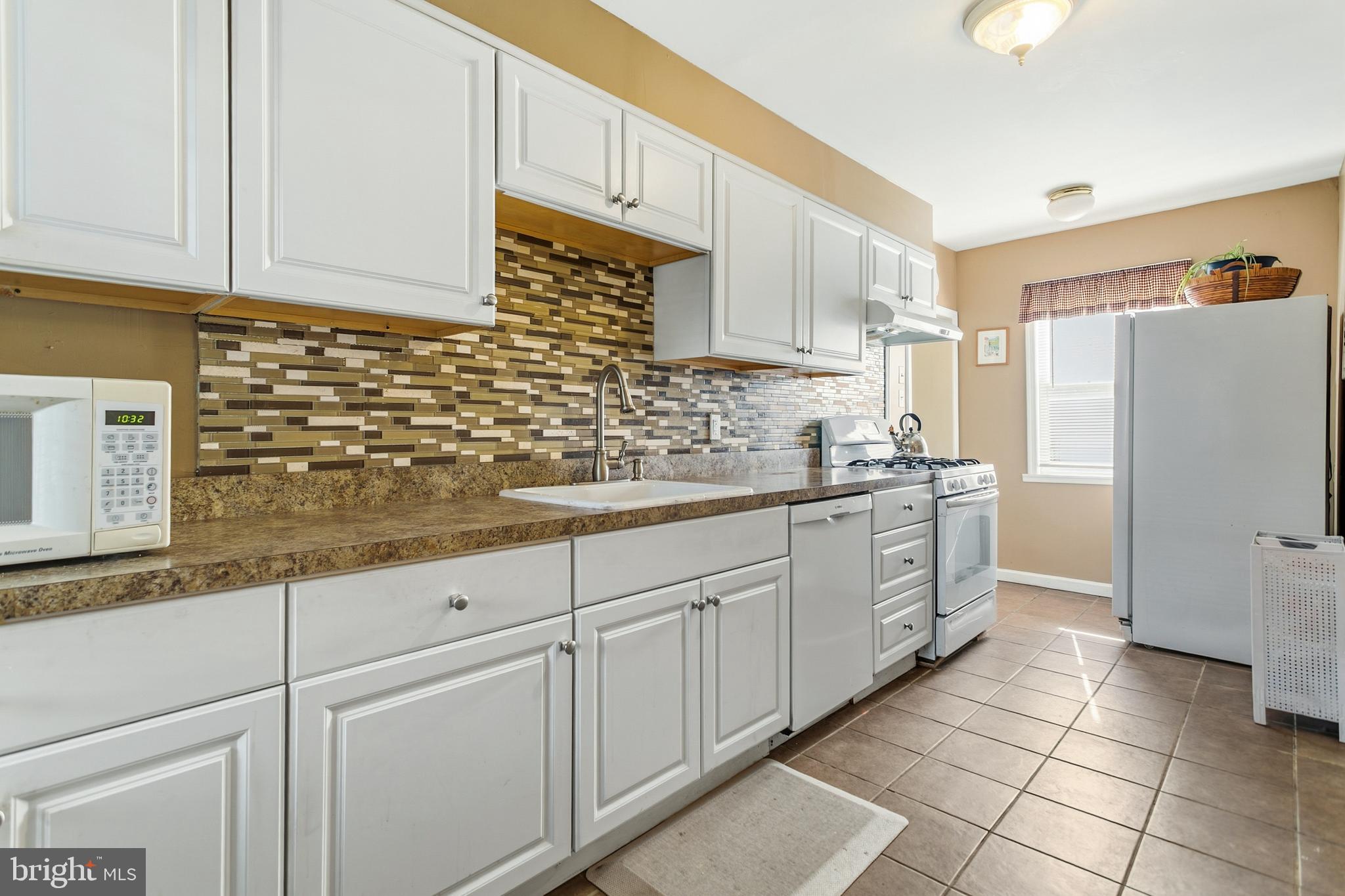 341 Owen Avenue Lansdowne, PA 19050 - Photo 17 of 58 a kitchen with granite countertop white cabinets and white appliances
