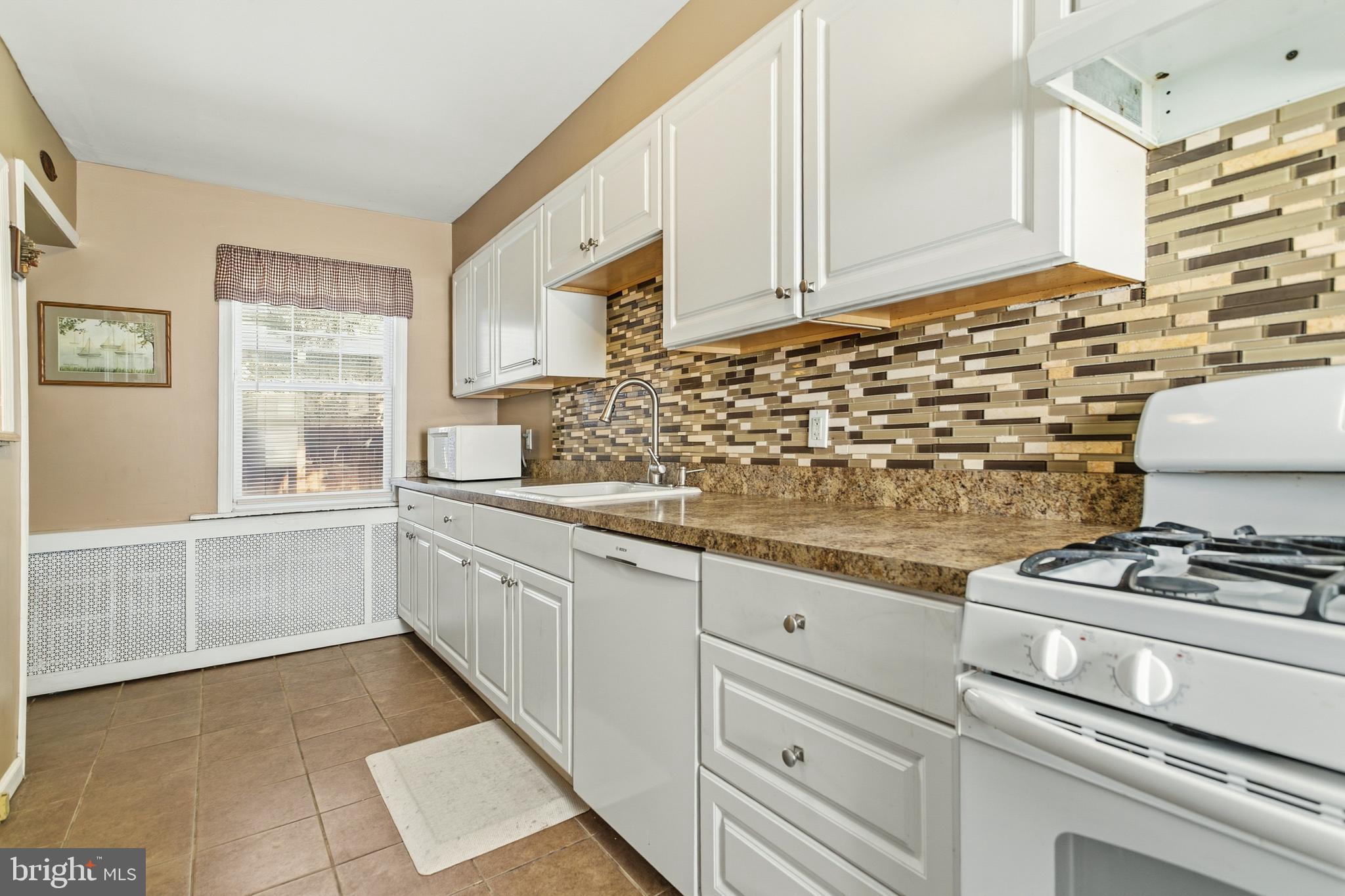 341 Owen Avenue Lansdowne, PA 19050 - Photo 18 of 58 a kitchen with granite countertop a stove sink and cabinets