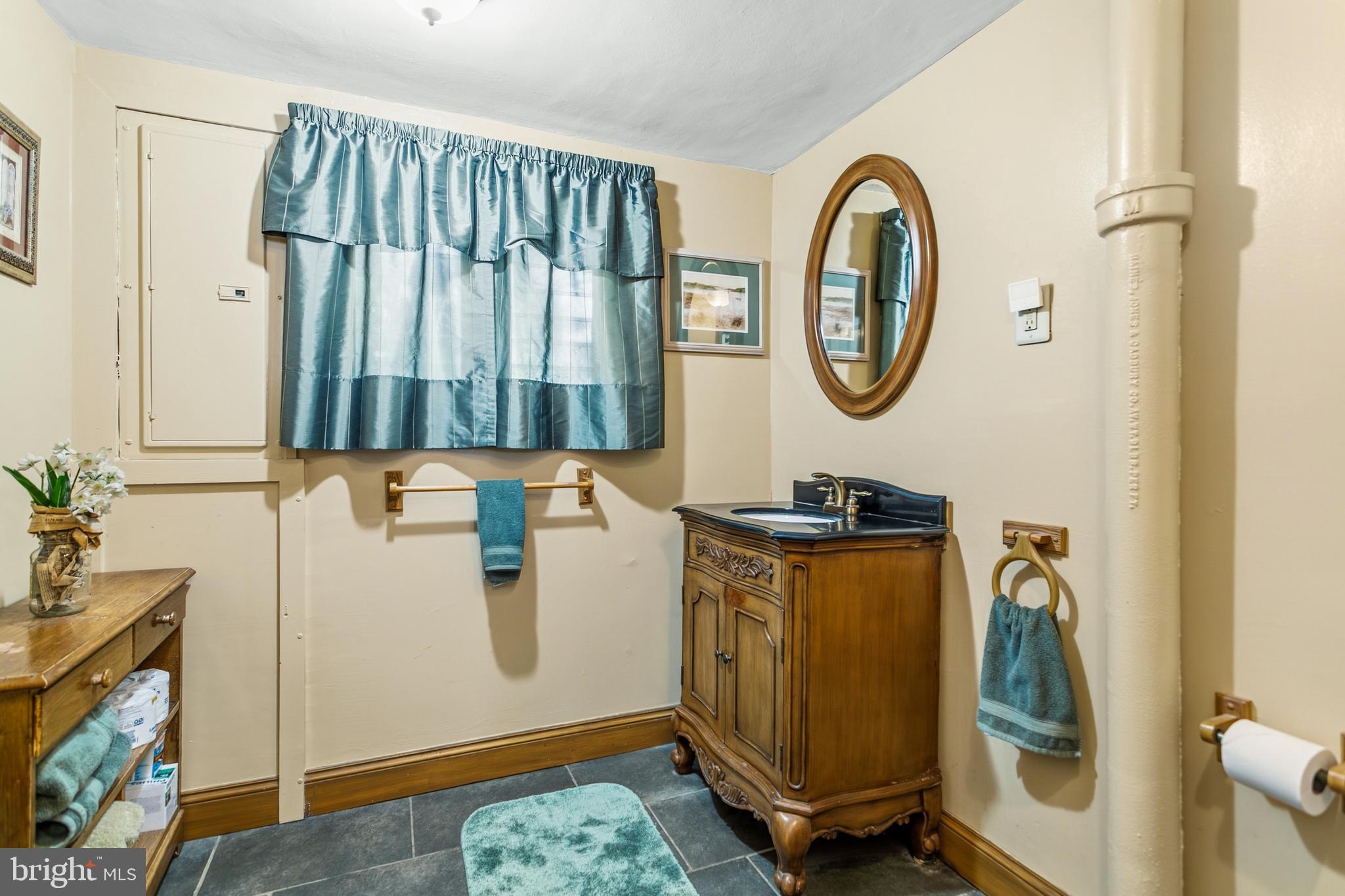 341 Owen Avenue Lansdowne, PA 19050 - Photo 21 of 58 a bathroom with a granite countertop sink and a mirror