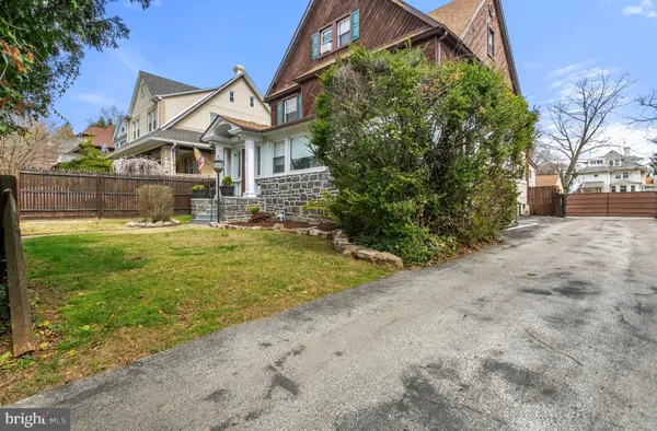 a front view of a house with yard and green space