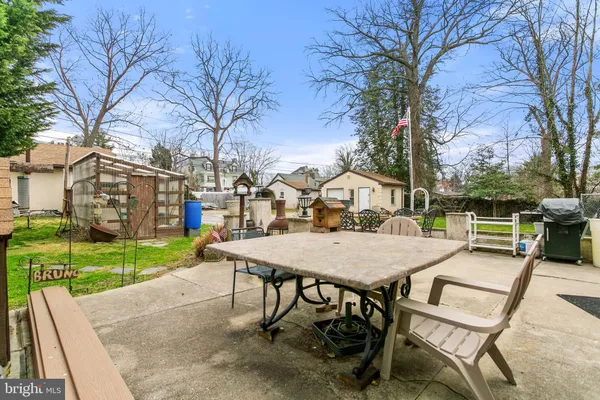 a view of a house with a big yard and fountain