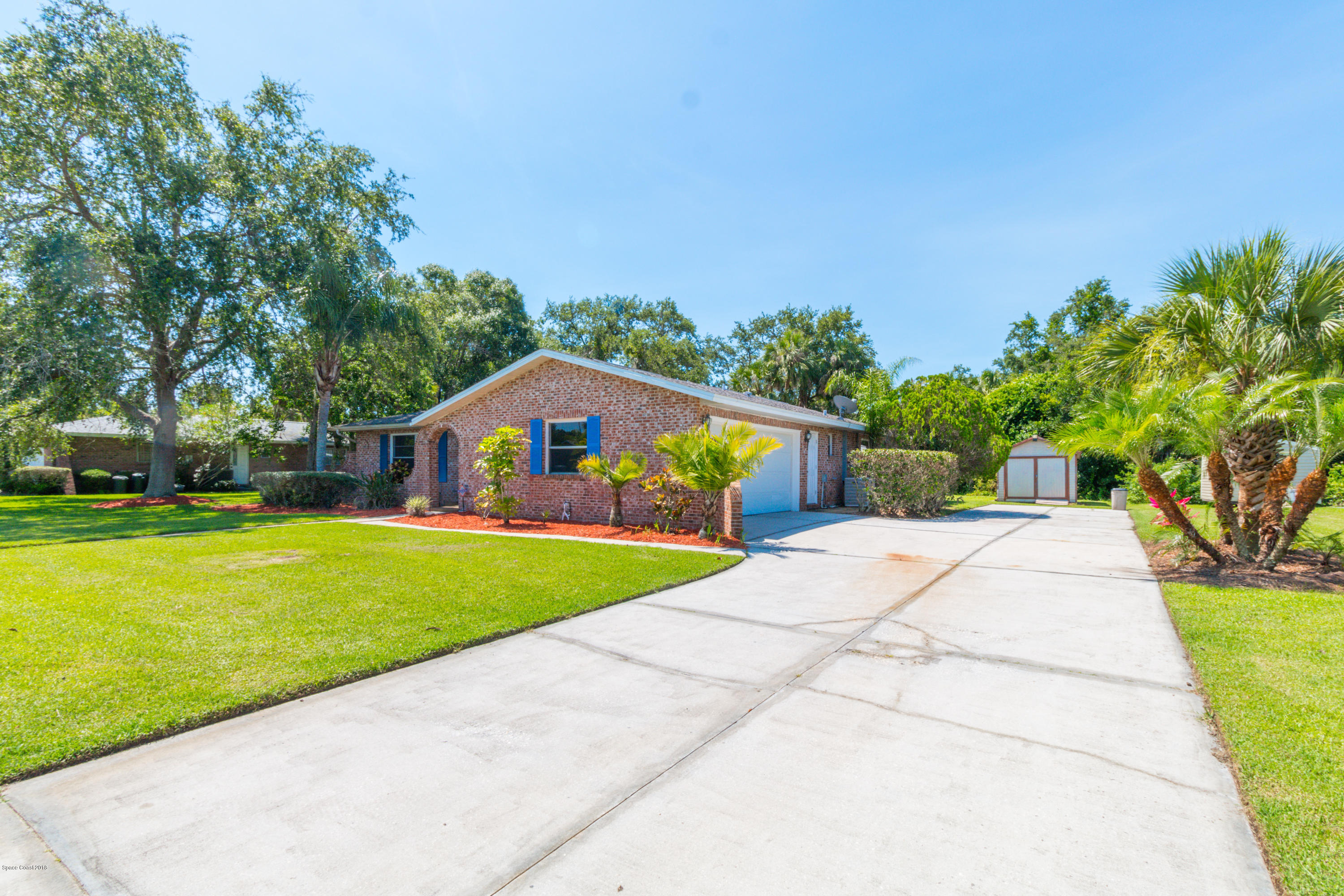 1208 Cimarron Circle Northeast Palm Bay, FL 32905 - Photo 3 of 41 a front view of house with yard