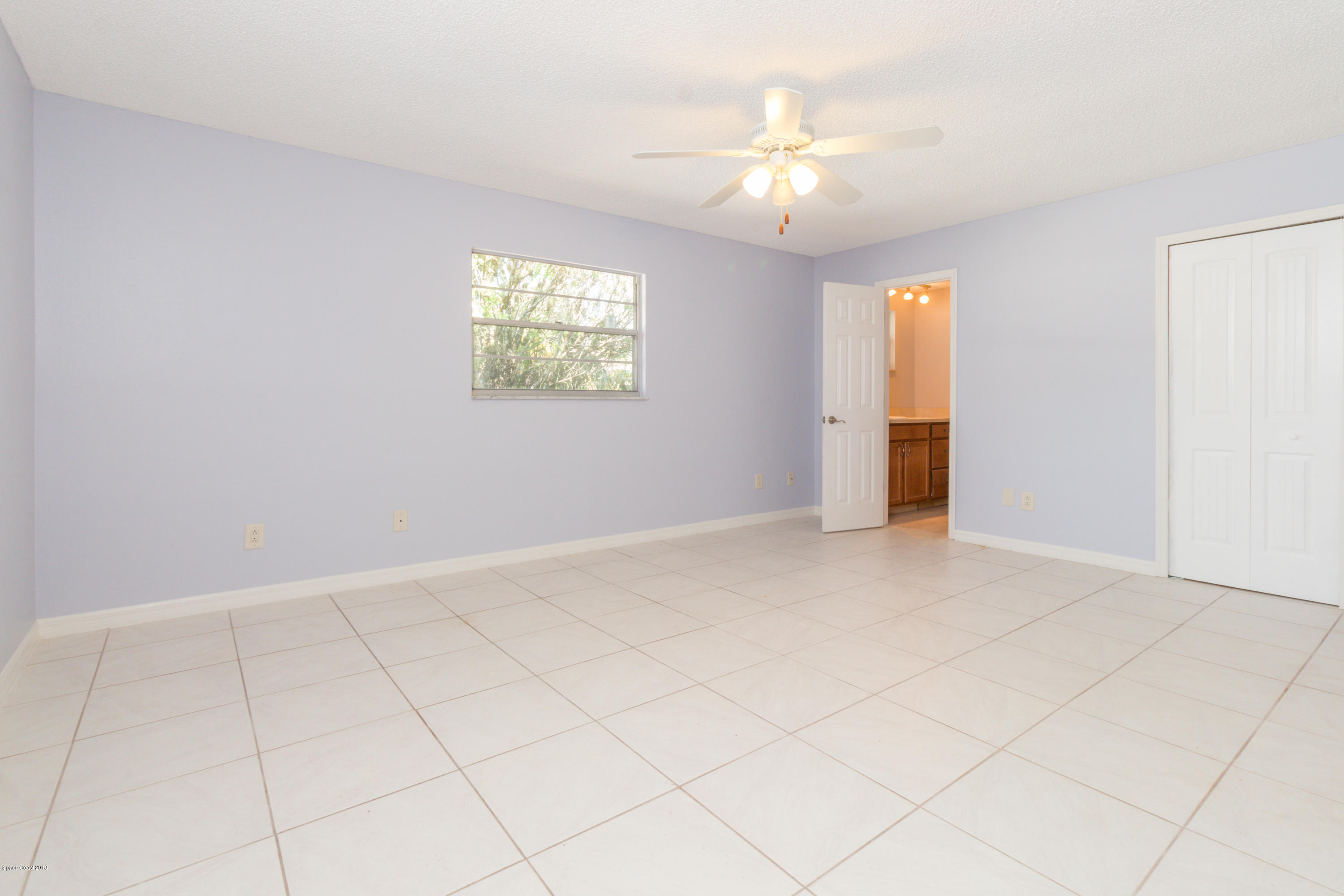 1208 Cimarron Circle Northeast Palm Bay, FL 32905 - Photo 21 of 41 a view of an empty room with a chandelier fan