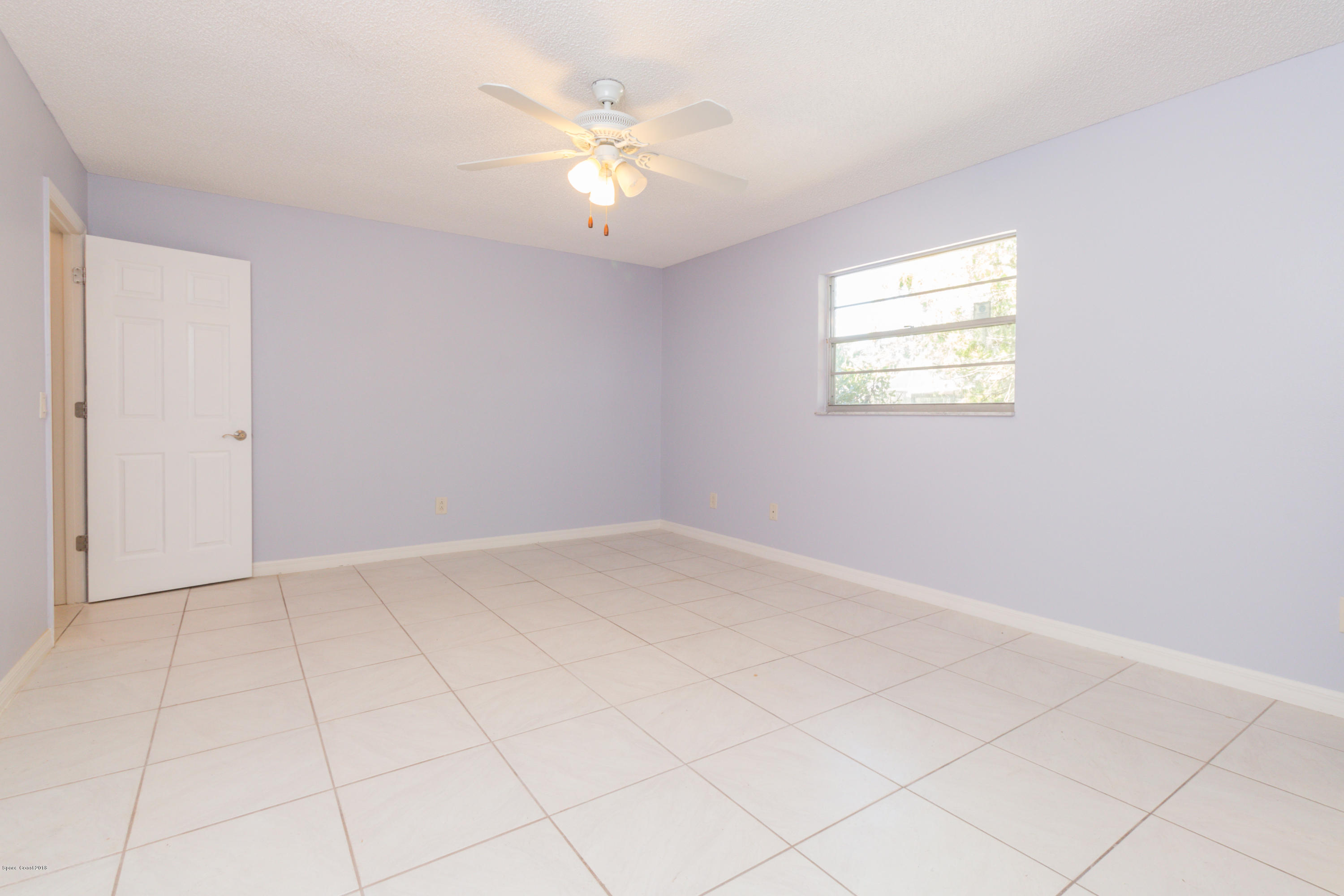 1208 Cimarron Circle Northeast Palm Bay, FL 32905 - Photo 24 of 41 an empty room with chandelier fan