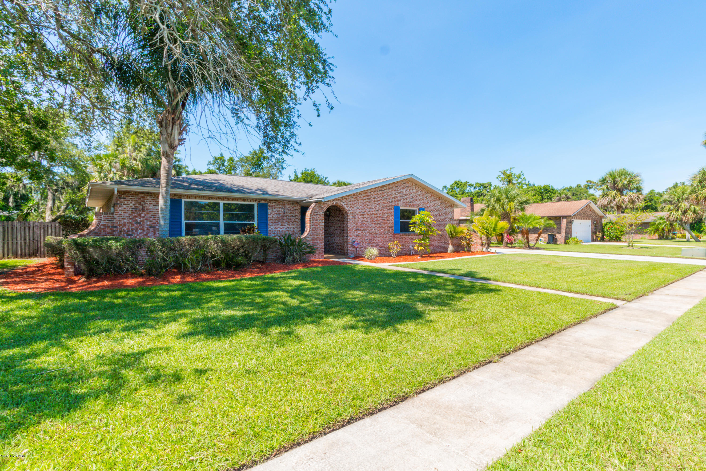 1208 Cimarron Circle Northeast Palm Bay, FL 32905 - Photo 4 of 41 a front view of house with yard and outdoor seating