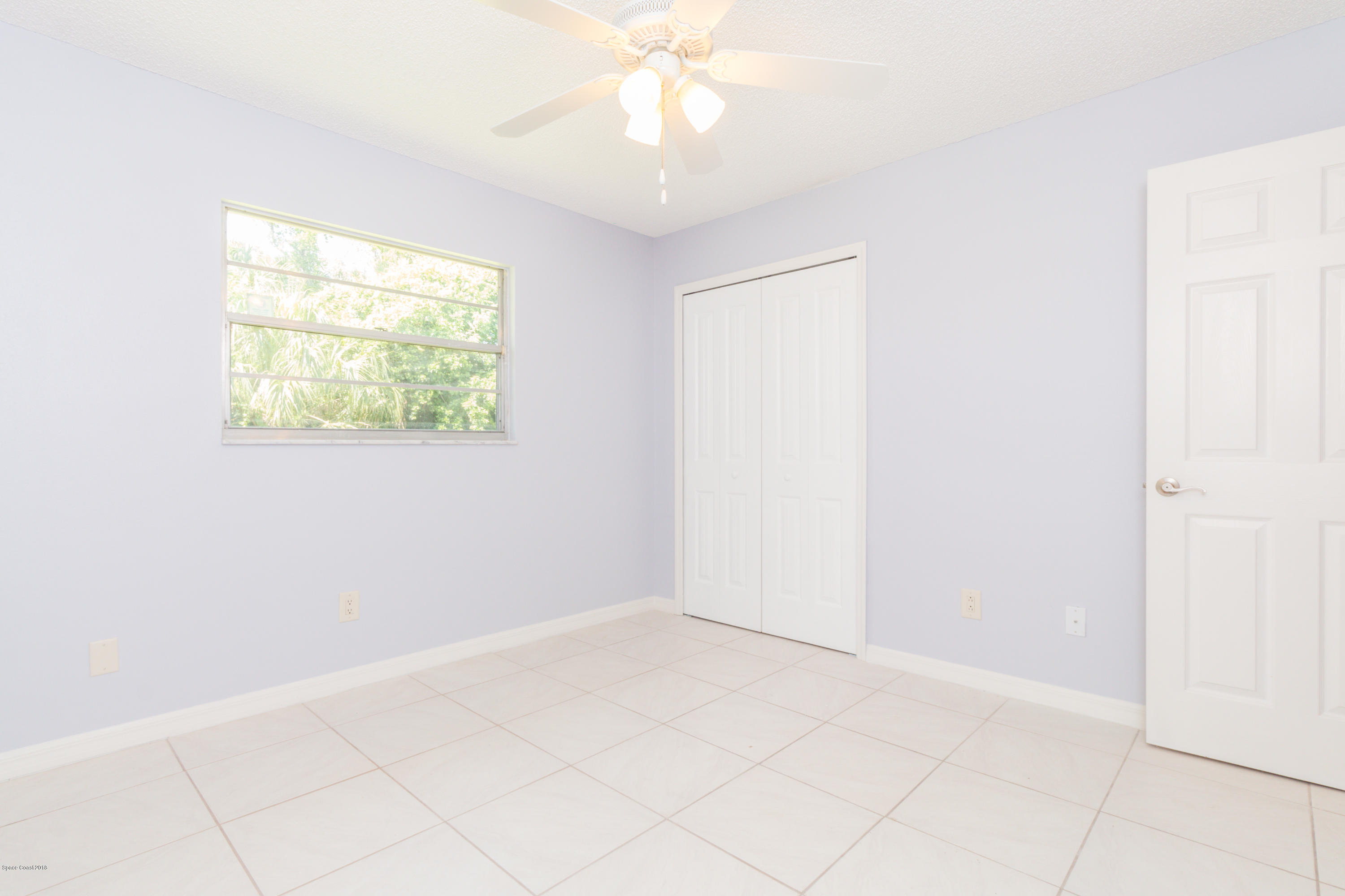 1208 Cimarron Circle Northeast Palm Bay, FL 32905 - Photo 31 of 41 an empty room with windows and closet