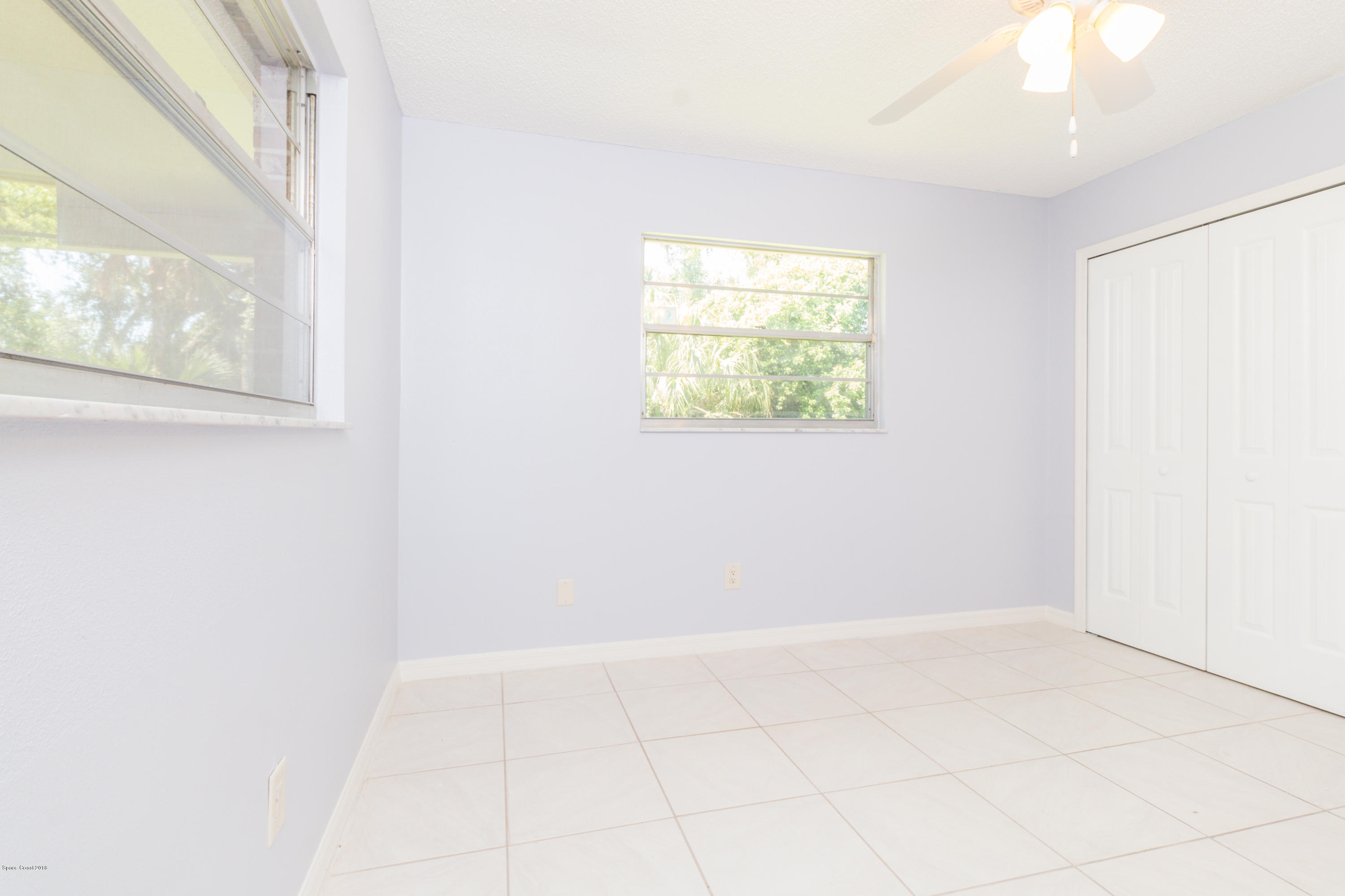 1208 Cimarron Circle Northeast Palm Bay, FL 32905 - Photo 32 of 41 an empty room with windows