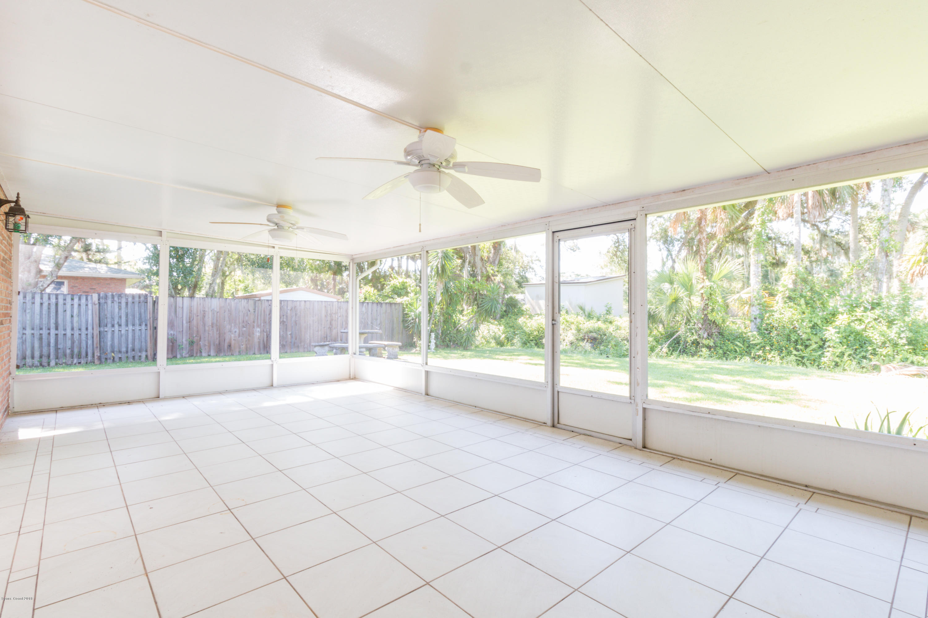 1208 Cimarron Circle Northeast Palm Bay, FL 32905 - Photo 37 of 41 a view of an empty room and a sliding door