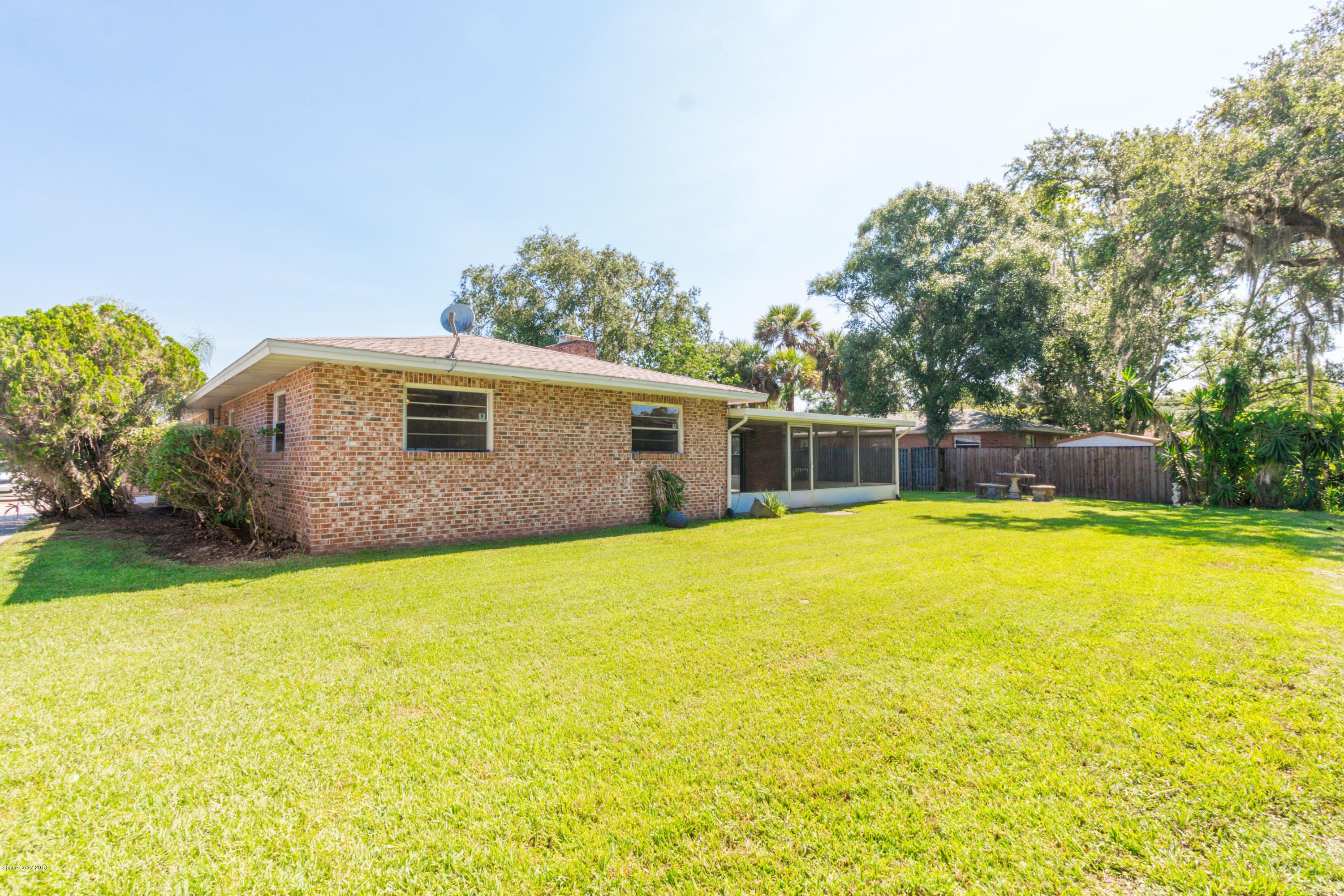 1208 Cimarron Circle Northeast Palm Bay, FL 32905 - Photo 39 of 41 a house view with swimming pool in front of it