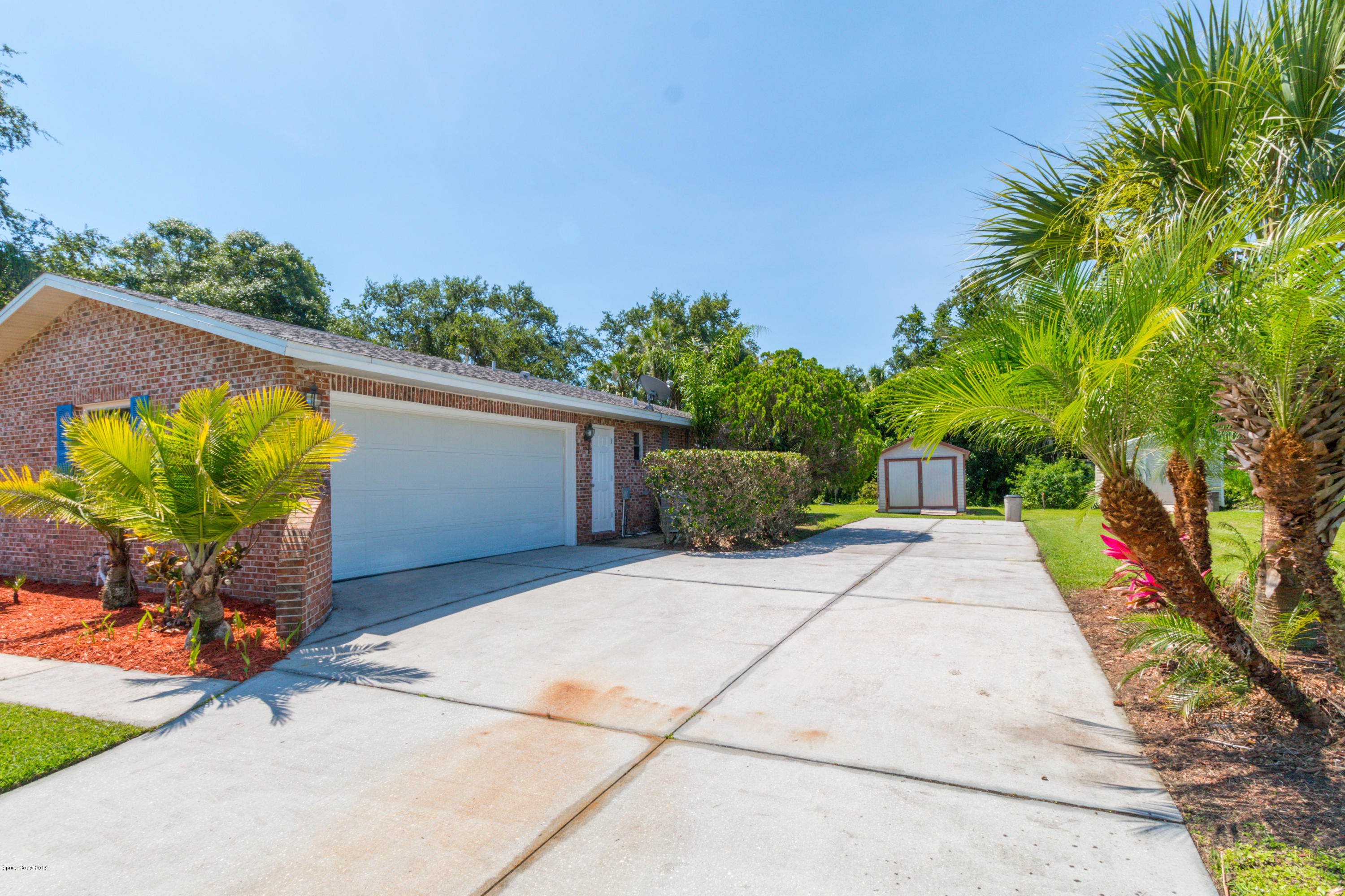 1208 Cimarron Circle Northeast Palm Bay, FL 32905 - Photo 5 of 41 a view of a back yard with potted plants