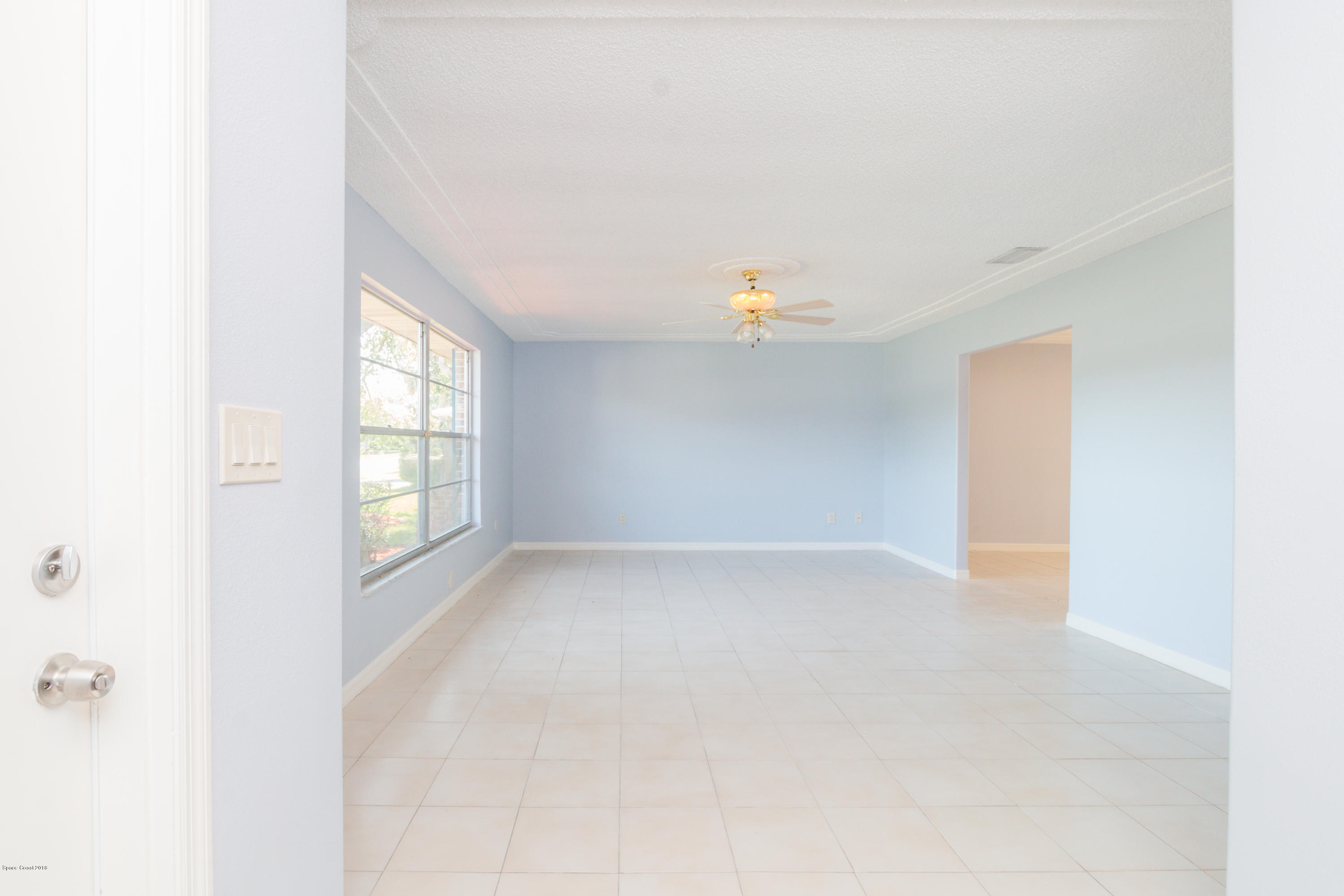 1208 Cimarron Circle Northeast Palm Bay, FL 32905 - Photo 8 of 41 a view of an empty room with a window