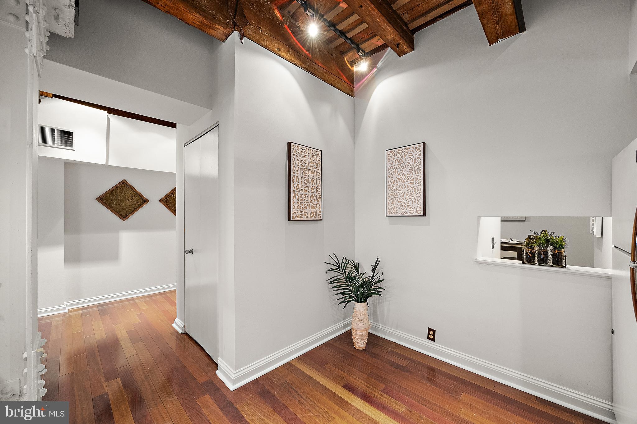 49 Bancroft Mills Road, Unit 2I Wilmington, DE 19806 - Photo 8 of 27 a view of a hallway with wooden floor and front door