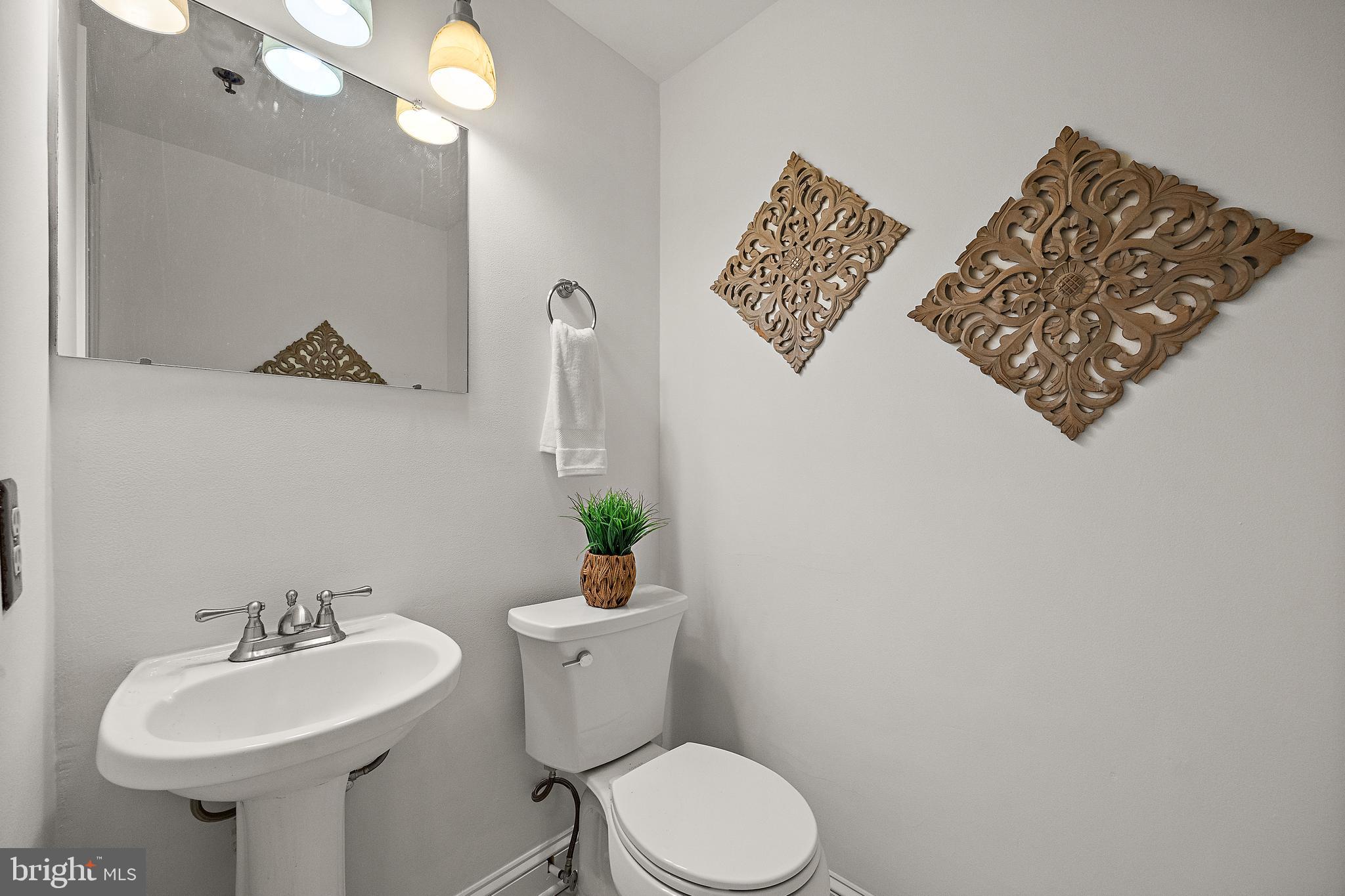 49 Bancroft Mills Road, Unit 2I Wilmington, DE 19806 - Photo 9 of 27 a bathroom with a toilet sink and mirror