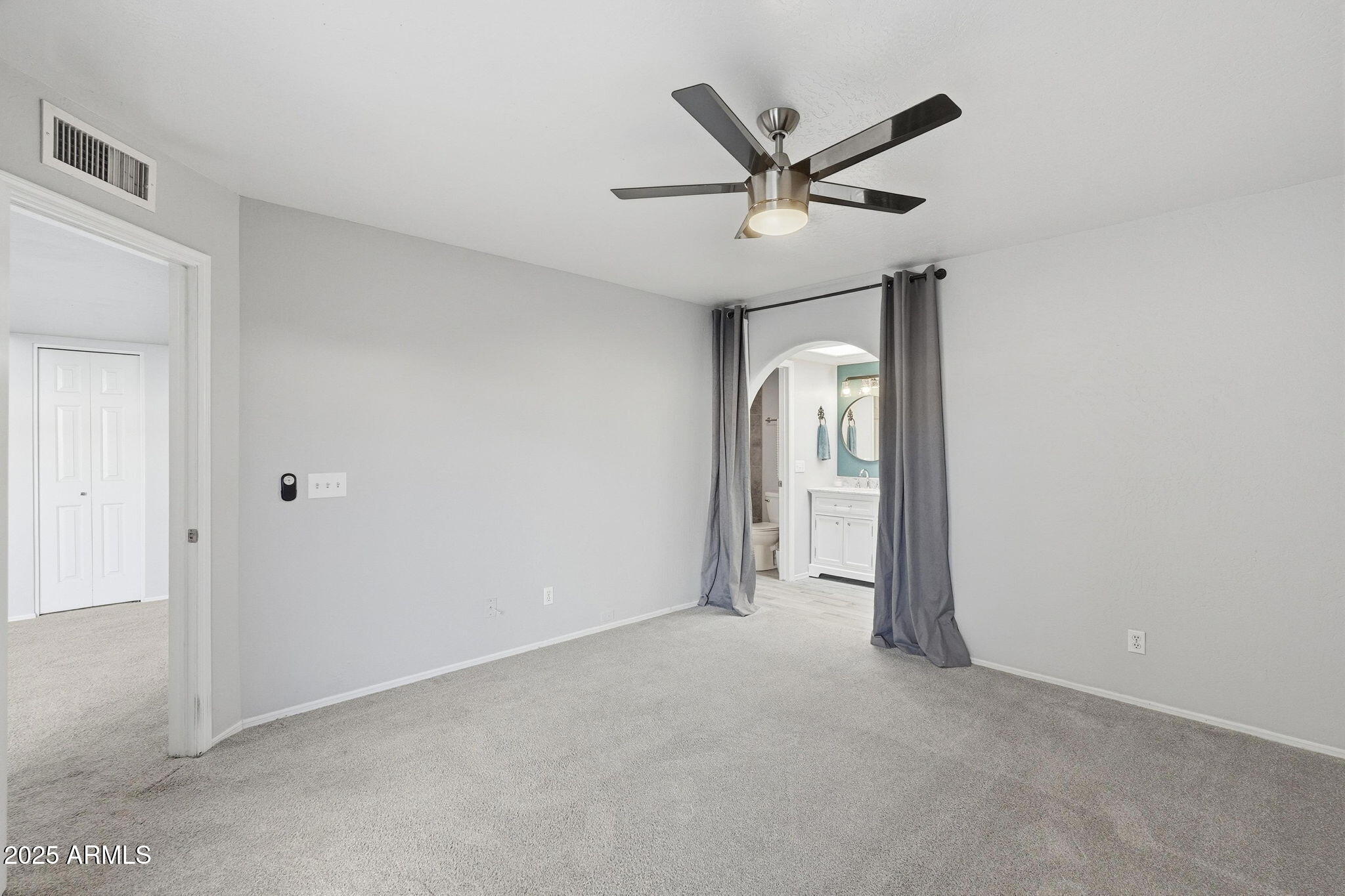 18002 North 12th Street, Unit 26 Phoenix, AZ 85022 - Photo 12 of 25 a view of a livingroom with a ceiling fan and wooden floor