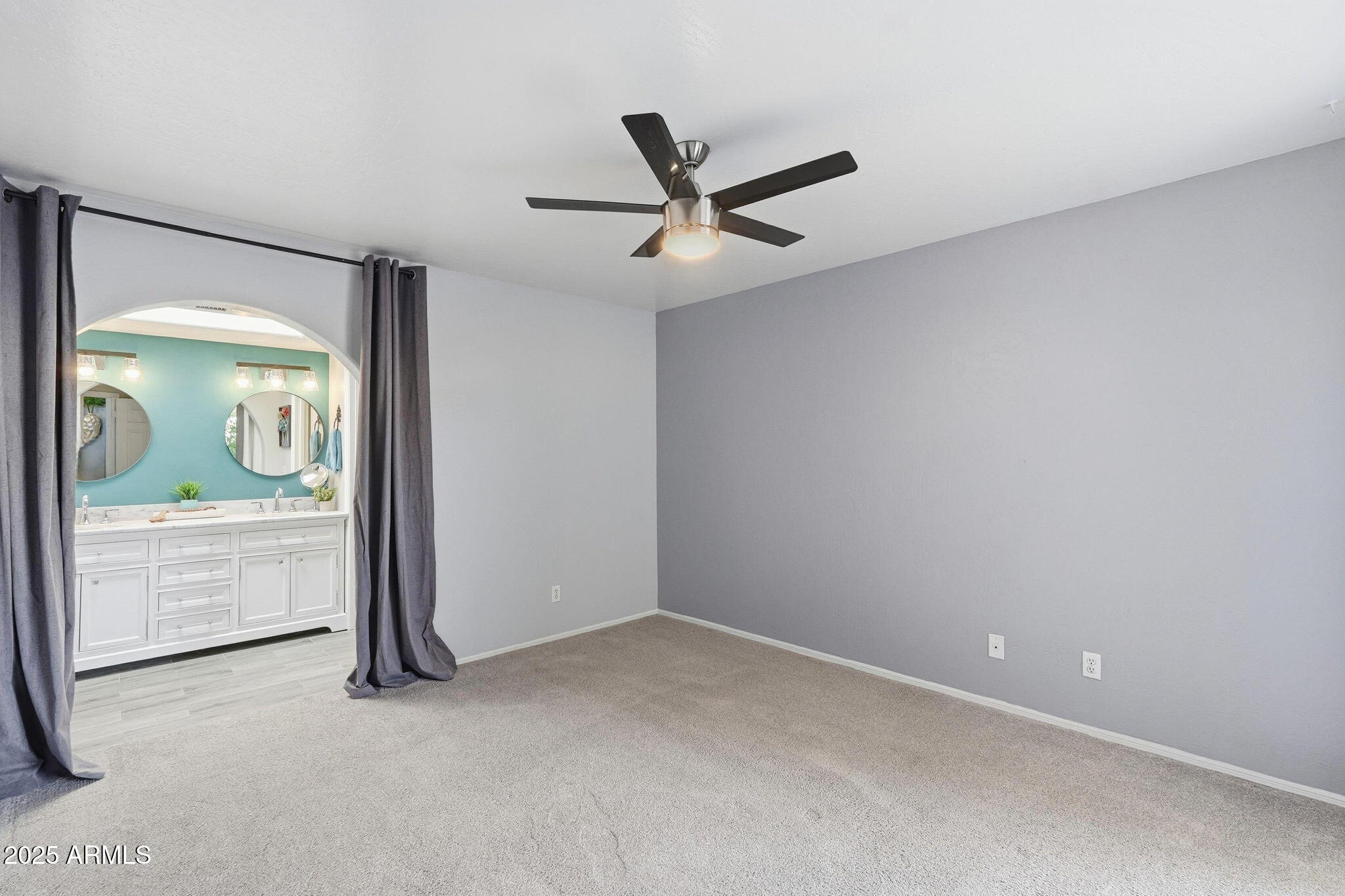 18002 North 12th Street, Unit 26 Phoenix, AZ 85022 - Photo 13 of 25 an empty room with a window and a ceiling fan