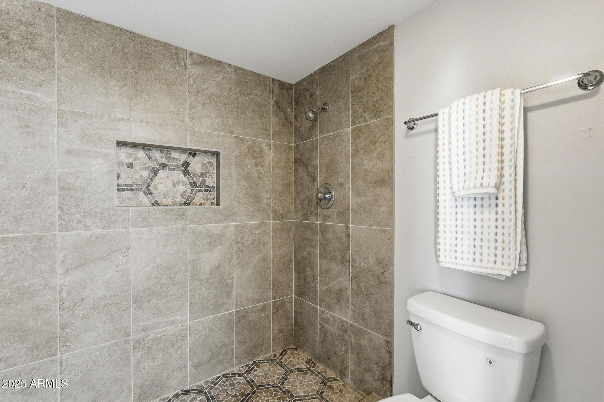 18002 North 12th Street, Unit 26 Phoenix, AZ 85022 - Photo 15 of 25 a bathroom with a toilet and a shower