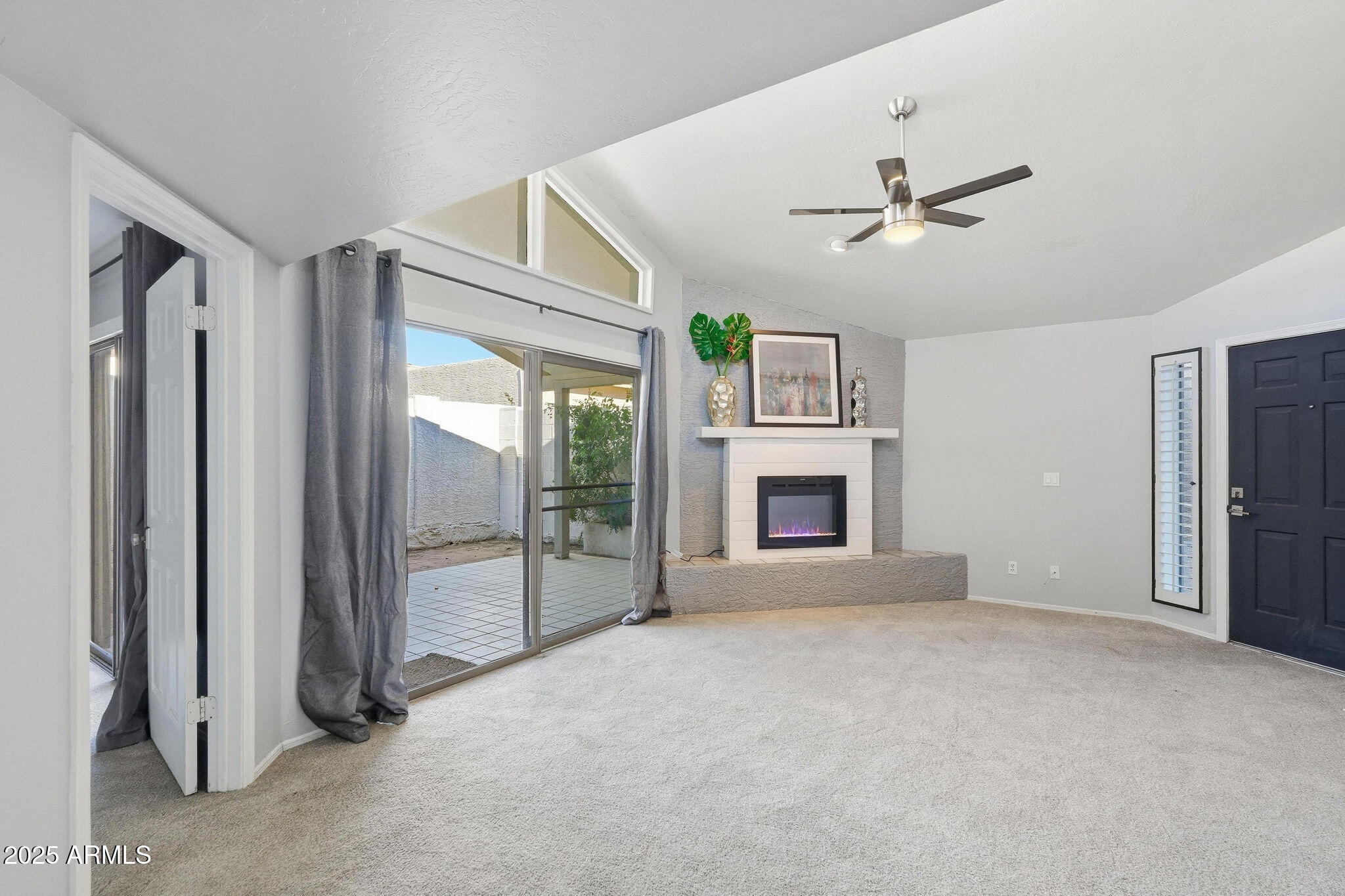 18002 North 12th Street, Unit 26 Phoenix, AZ 85022 - Photo 5 of 25 a view of an empty room with a fireplace