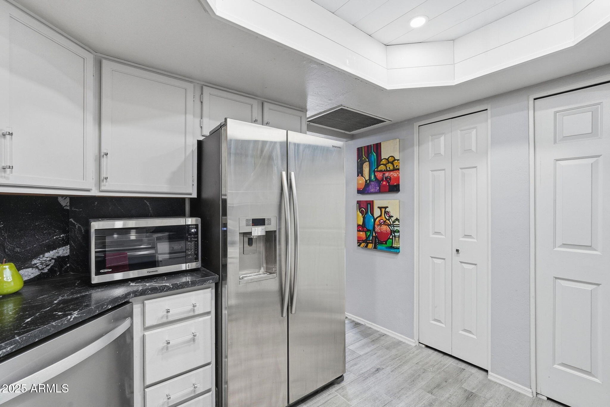 18002 North 12th Street, Unit 26 Phoenix, AZ 85022 - Photo 9 of 25 a kitchen with stainless steel appliances granite countertop a refrigerator and a stove top oven