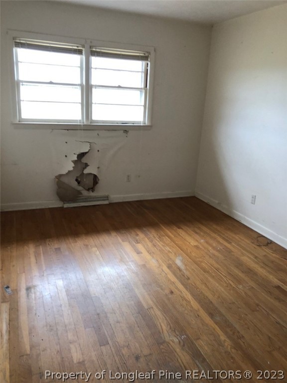 199 Herring Road Orrum, NC 28369 - Photo 15 of 20 an empty room with wooden floor and windows