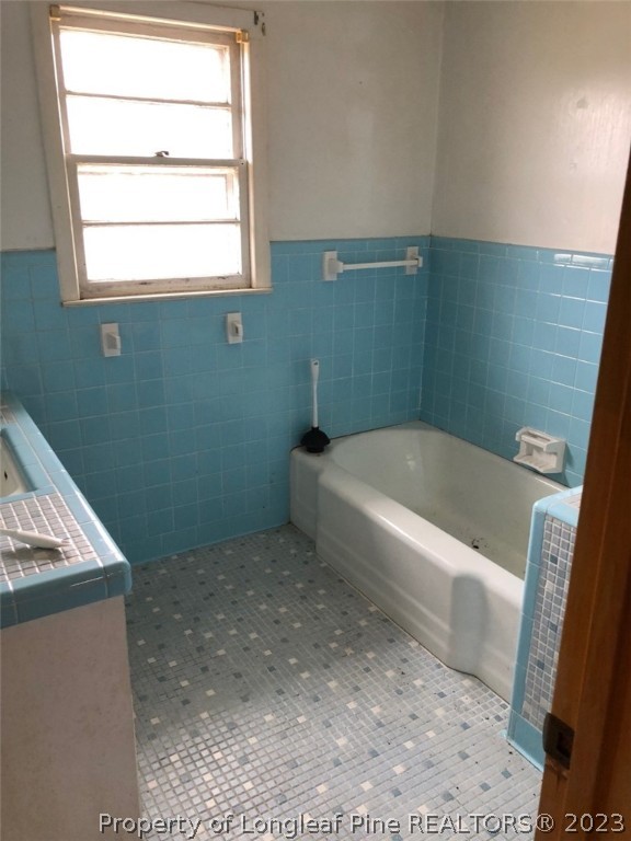 199 Herring Road Orrum, NC 28369 - Photo 18 of 20 a bath tub sitting in a bathroom next to a sink