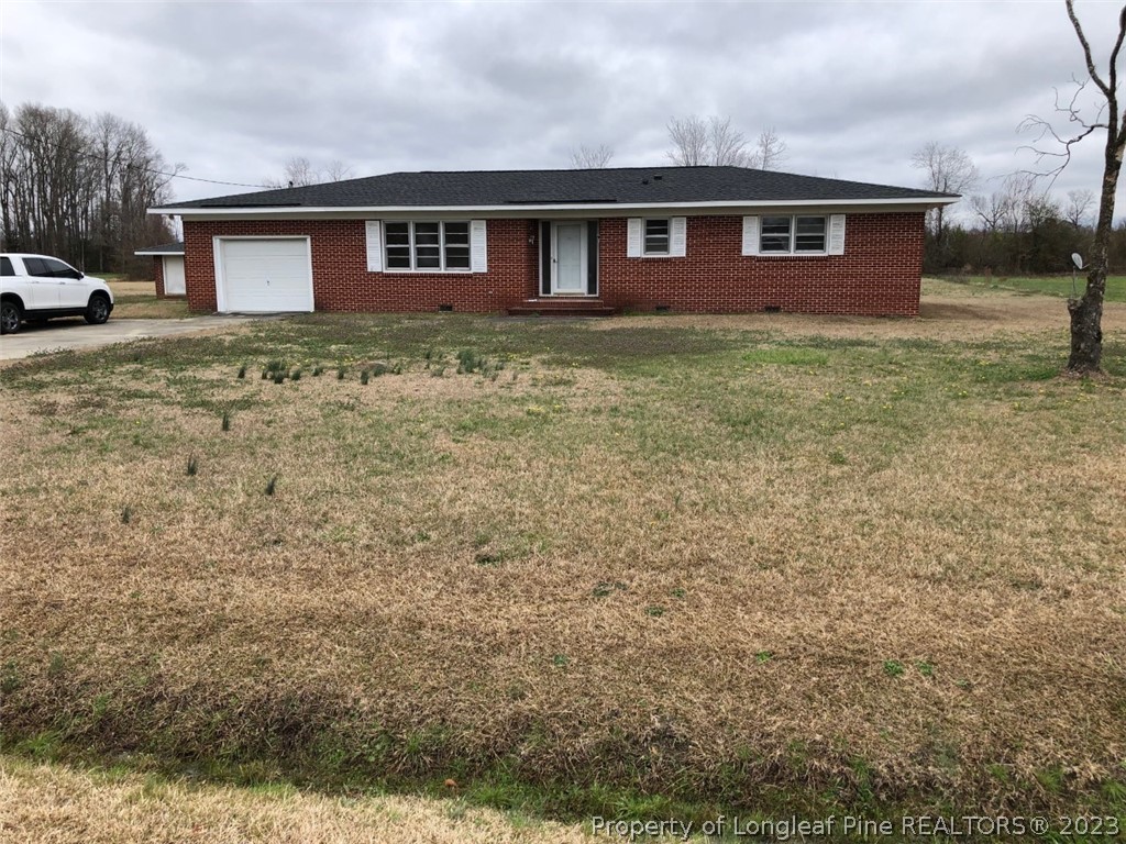 199 Herring Road Orrum, NC 28369 - Photo 2 of 20 a front view of a house with yard