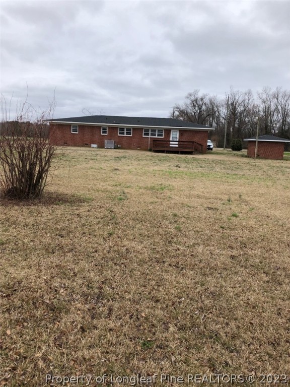 199 Herring Road Orrum, NC 28369 - Photo 5 of 20 a view of swimming pool with lawn chairs and iron fence