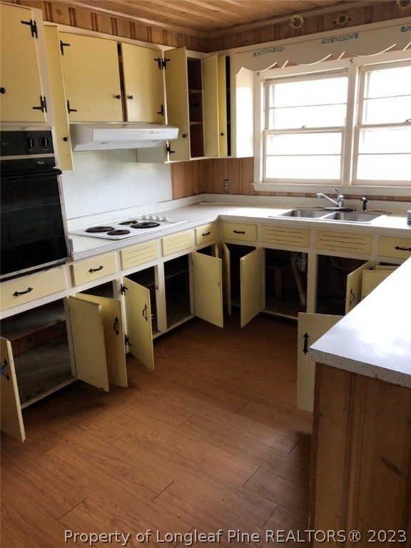 199 Herring Road Orrum, NC 28369 - Photo 10 of 20 a kitchen with a sink stove top oven and cabinets