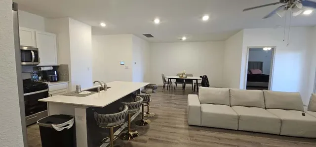 a living room with furniture and a wooden floor