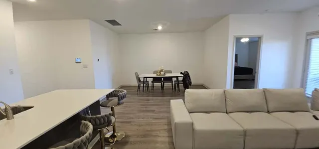 a living room with furniture and wooden floor