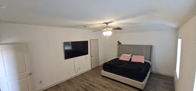 a bedroom with a bed and a flat screen tv