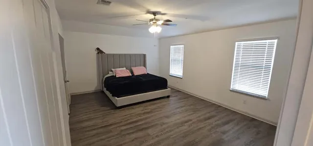 a living room with a bed furniture and a window
